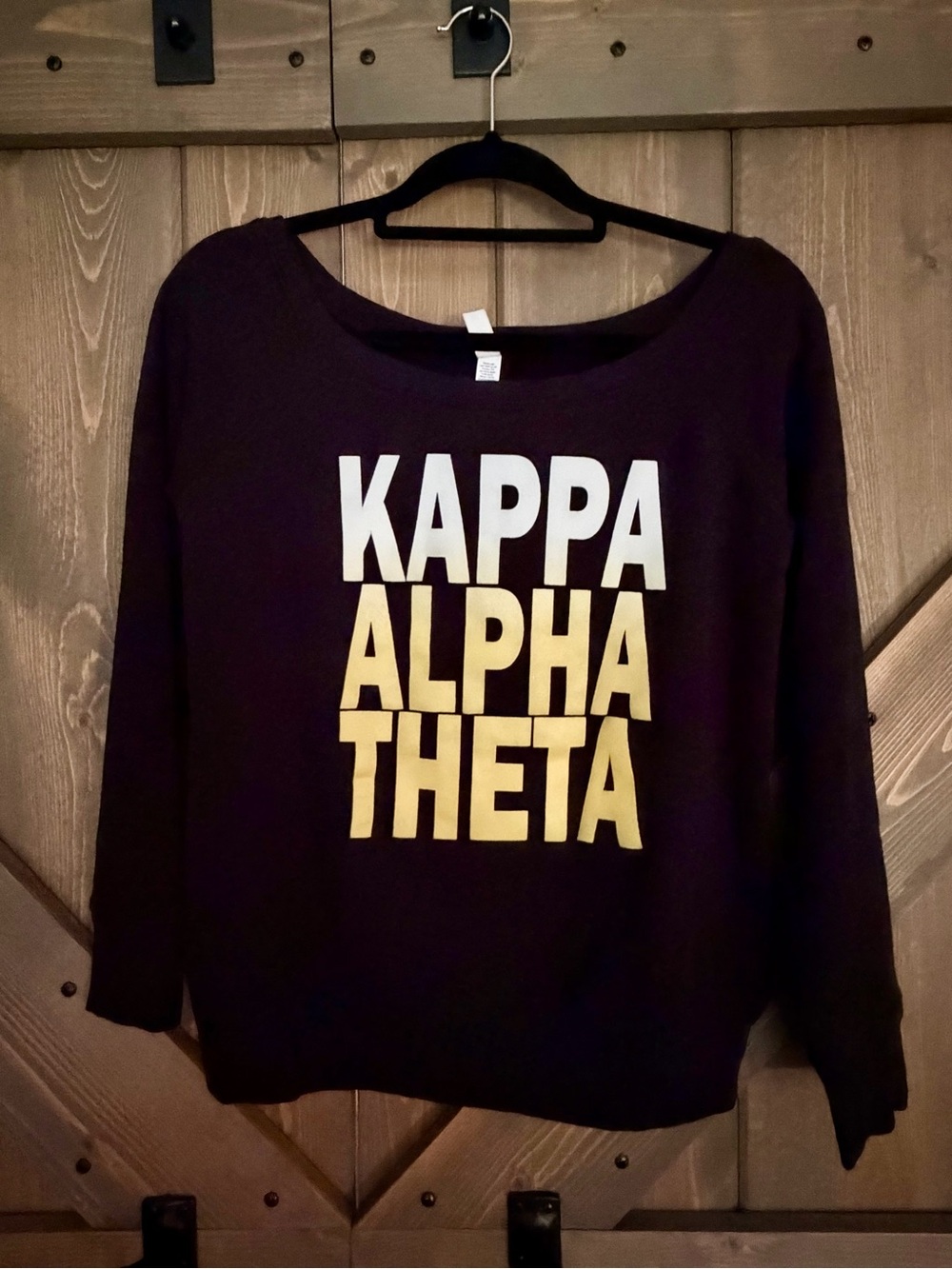 Black Crewneck Sweatshirt with White and Gold Lettering